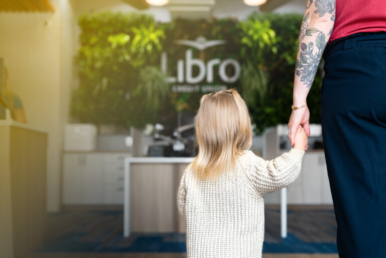 Mother and daughter holding hands in a Libro branch